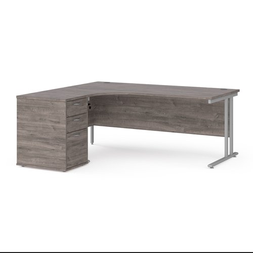Maestro 25 left hand ergonomic desk 1800mm with silver cantilever frame and desk high pedestal - grey oak